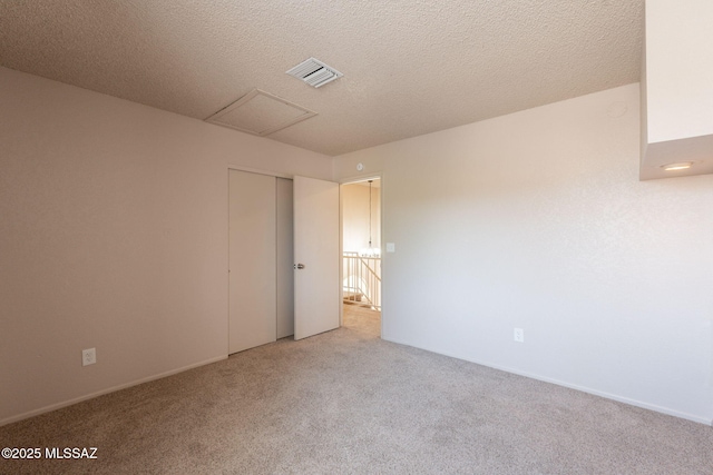 3556 W Avenida Del Mar, Tucson, AZ 85746 - empty room with light colored carpet, attic access, and a textured ceiling