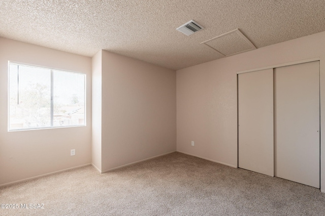 3556 W Avenida Del Mar, Tucson, AZ 85746 - unfurnished bedroom with attic access, carpet, a closet, and a textured ceiling