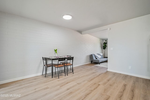 3872 S Evergreen Ave, Tucson, AZ 85730 - dining room featuring brick wall and light wood-style floors