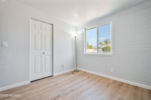 3872 S Evergreen Ave, Tucson, AZ 85730 - unfurnished bedroom featuring wood finished floors and a closet