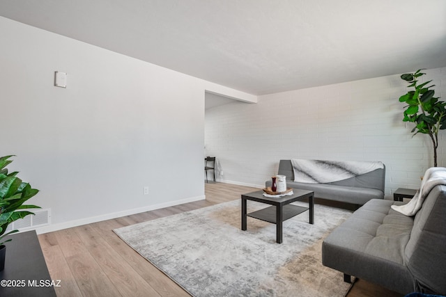 3872 S Evergreen Ave, Tucson, AZ 85730 - living area featuring wood finished floors and brick wall