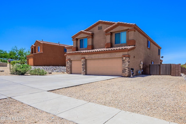 738 S Willis Ray Ave, Vail, AZ 85641 - mediterranean / spanish home with concrete driveway, stucco siding, a tile roof, an attached garage, and stone siding