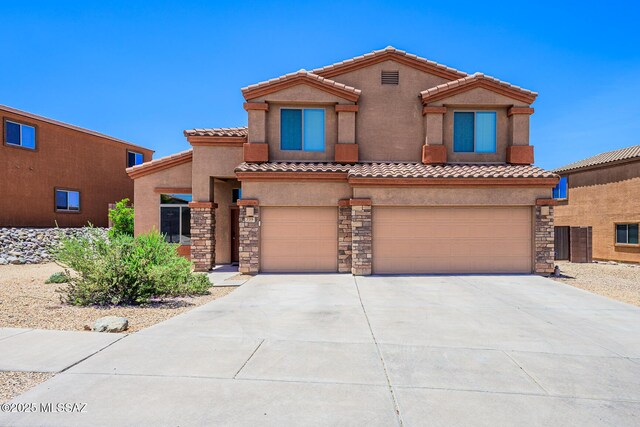 738 S Willis Ray Ave, Vail, AZ 85641 - view of front of house with a garage, stone siding, stucco siding, and driveway