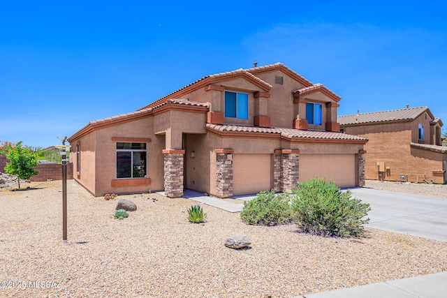 738 S Willis Ray Ave, Vail, AZ 85641 - mediterranean / spanish-style house with a garage, stucco siding, a tiled roof, concrete driveway, and stone siding