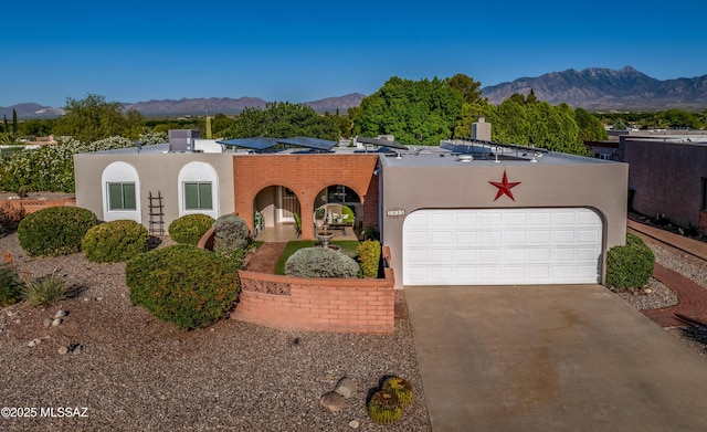 1939 S San Vincent Dr, Green Valley, AZ 85614 - view of front facade featuring an attached garage, a mountain view, concrete driveway, and stucco siding