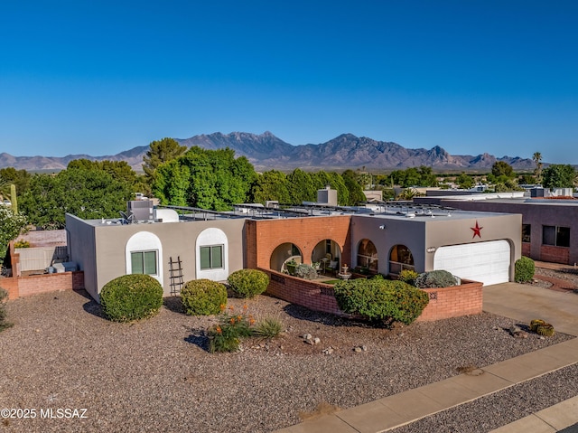 1939 S San Vincent Dr, Green Valley, AZ 85614 - view of front of property with a garage, stucco siding, and a mountain view