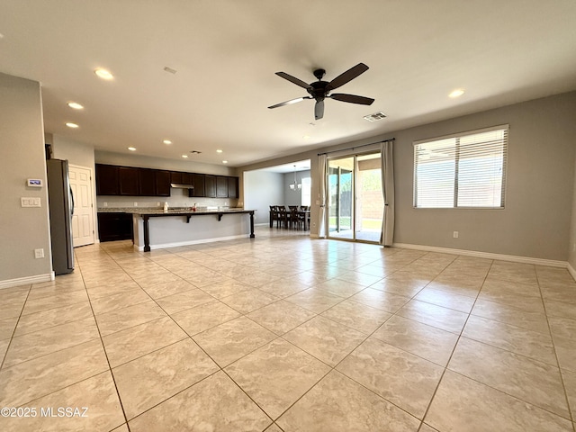 9636 N Havenwood Way, Marana, AZ 85653 - unfurnished living room with light tile patterned flooring, recessed lighting, and ceiling fan