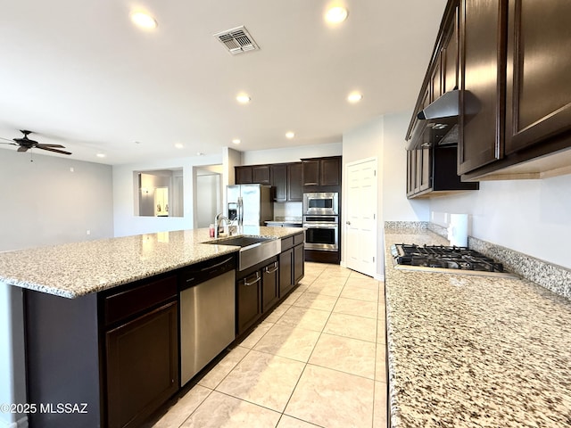 9636 N Havenwood Way, Marana, AZ 85653 - kitchen with appliances with stainless steel finishes, range hood, recessed lighting, a kitchen island with sink, and a ceiling fan