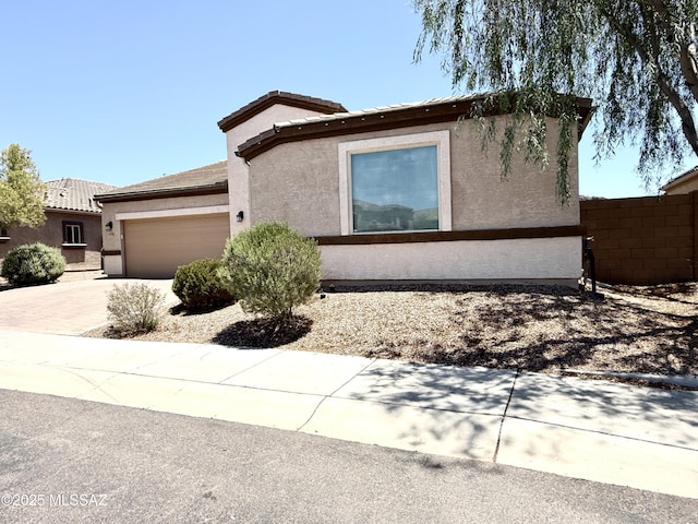 9636 N Havenwood Way, Marana, AZ 85653 - view of front of property with stucco siding, an attached garage, and driveway