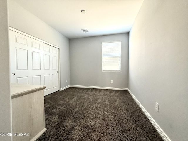 9636 N Havenwood Way, Marana, AZ 85653 - unfurnished bedroom featuring dark carpet and baseboards