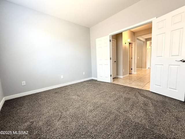 9636 N Havenwood Way, Marana, AZ 85653 - unfurnished bedroom with light carpet and light tile patterned floors
