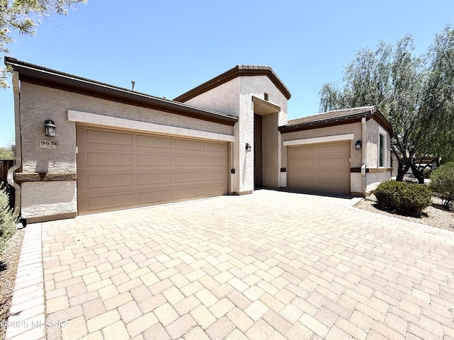 9636 N Havenwood Way, Marana, AZ 85653 - view of front of property with a garage, decorative driveway, and stucco siding