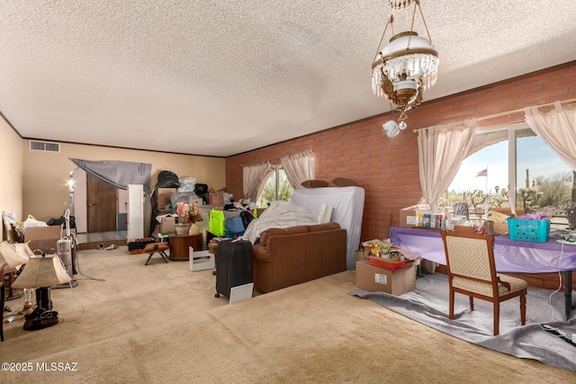 10901 N Camino De Oeste, Tucson, AZ 85742 - bedroom with carpet flooring, a textured ceiling, a chandelier, and brick wall