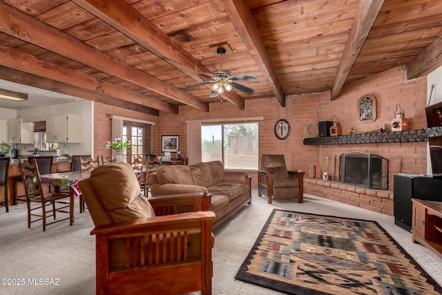 10901 N Camino De Oeste, Tucson, AZ 85742 - living room featuring light colored carpet, a wooden ceiling with exposed beams, a ceiling fan, brick wall, and a fireplace