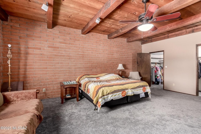 10901 N Camino De Oeste, Tucson, AZ 85742 - carpeted bedroom with a wooden ceiling with exposed beams, brick wall, a walk in closet, and ceiling fan