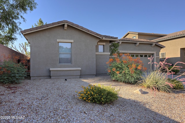 817 E Deer Spring Canyon Pl, Sahuarita, AZ 85629 - view of front facade featuring an attached garage, a tiled roof, and stucco siding