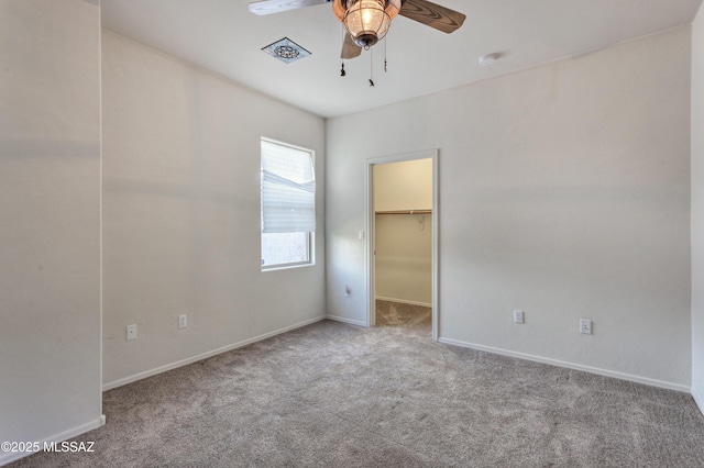 817 E Deer Spring Canyon Pl, Sahuarita, AZ 85629 - unfurnished bedroom with carpet flooring, a walk in closet, and a ceiling fan