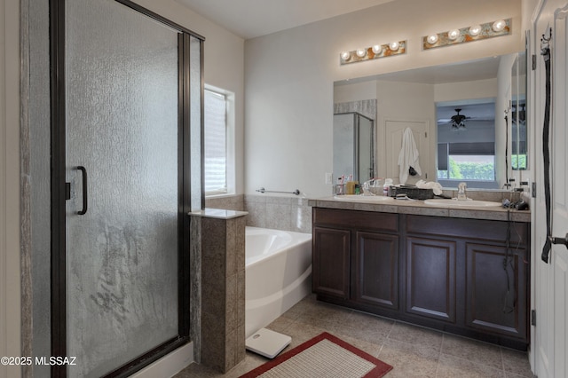 817 E Deer Spring Canyon Pl, Sahuarita, AZ 85629 - full bathroom featuring a shower stall, double vanity, a bath, a ceiling fan, and tile patterned flooring