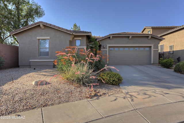 817 E Deer Spring Canyon Pl, Sahuarita, AZ 85629 - view of front of home featuring driveway, stucco siding, a garage, and a tiled roof