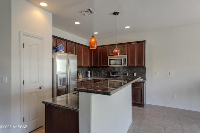 817 E Deer Spring Canyon Pl, Sahuarita, AZ 85629 - kitchen with stainless steel appliances, decorative backsplash, dark stone counters, hanging light fixtures, and recessed lighting