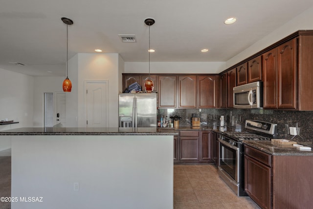 817 E Deer Spring Canyon Pl, Sahuarita, AZ 85629 - kitchen with stainless steel appliances, a kitchen island, dark stone countertops, decorative backsplash, and recessed lighting