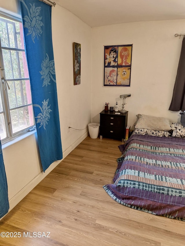 1036 S 4th Ave, Tucson, AZ 85701 - bedroom featuring wood finished floors and baseboards