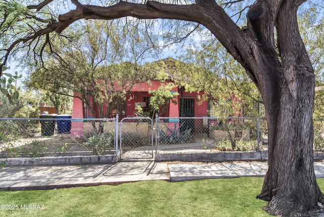 1036 S 4th Ave, Tucson, AZ 85701 - view of property hidden behind natural elements with a fenced front yard and a gate