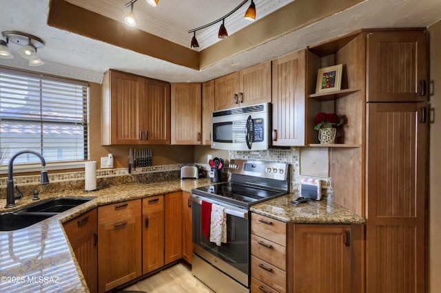 6651 N Campbell Ave Unit 286, Tucson, AZ 85718 - kitchen featuring appliances with stainless steel finishes, backsplash, light stone countertops, open shelves, and light wood finished floors