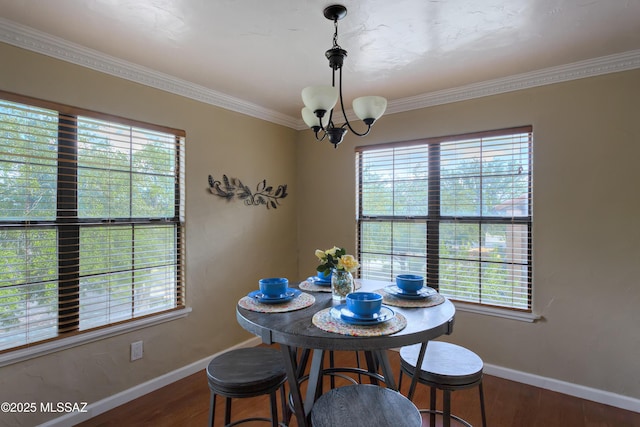 6651 N Campbell Ave Unit 286, Tucson, AZ 85718 - dining room featuring healthy amount of natural light, a chandelier, crown molding, and wood finished floors