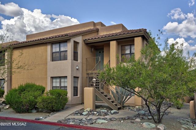 6651 N Campbell Ave Unit 286, Tucson, AZ 85718 - view of front of home featuring stucco siding, stairs, and a tile roof