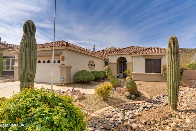 9223 N Crimson Stone Pl, Tucson, AZ 85743 - mediterranean / spanish-style home featuring an attached garage, stucco siding, a tile roof, and driveway