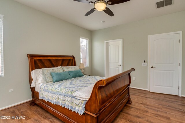 9223 N Crimson Stone Pl, Tucson, AZ 85743 - bedroom with wood finished floors and ceiling fan
