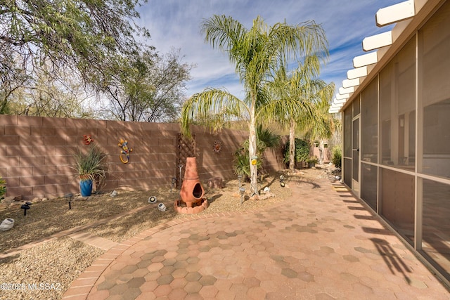 9223 N Crimson Stone Pl, Tucson, AZ 85743 - fenced backyard featuring a patio area and a sunroom