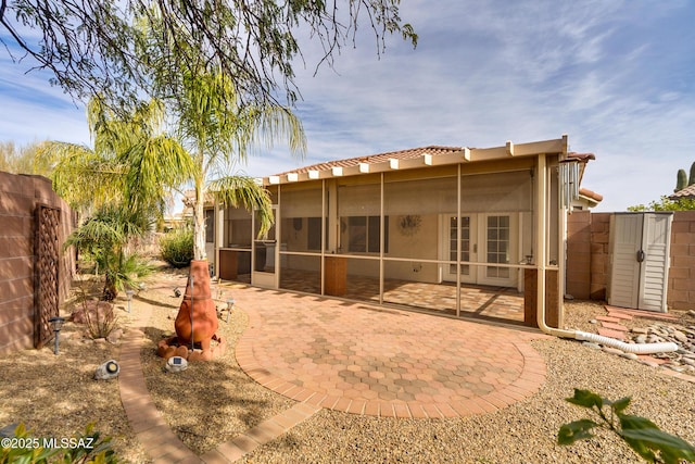 9223 N Crimson Stone Pl, Tucson, AZ 85743 - rear view of house with french doors, a patio, a sunroom, stucco siding, and a tile roof