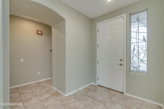 9223 N Crimson Stone Pl, Tucson, AZ 85743 - foyer entrance with arched walkways, healthy amount of natural light, and light tile patterned flooring