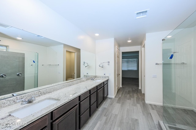 6860 E Via Arroyo Largo, Tucson, AZ 85756 - full bath featuring a walk in shower, double vanity, wood finished floors, and recessed lighting