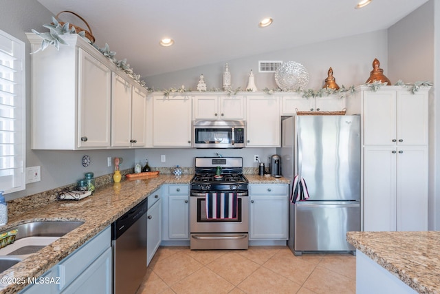 9908 E Shadow Glen Ct, Tucson, AZ 85748 - kitchen with stainless steel appliances, white cabinets, light tile patterned flooring, light stone counters, and recessed lighting