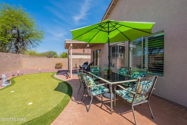 9908 E Shadow Glen Ct, Tucson, AZ 85748 - fenced backyard featuring a putting area, a patio area, and outdoor dining area