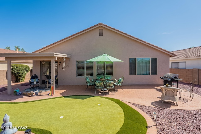 9908 E Shadow Glen Ct, Tucson, AZ 85748 - back of property with a putting green, a patio area, stucco siding, and a tile roof