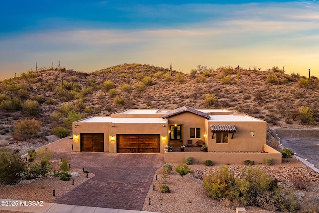 3188 W Tumamoc Dr, Tucson, AZ 85745 - pueblo-style home featuring a garage, stucco siding, and driveway