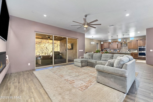 3188 W Tumamoc Dr, Tucson, AZ 85745 - living room with ceiling fan, light wood finished floors, recessed lighting, and a fireplace