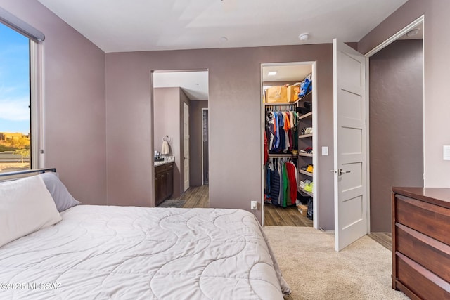 3188 W Tumamoc Dr, Tucson, AZ 85745 - bedroom featuring a walk in closet, multiple windows, a closet, and ensuite bath