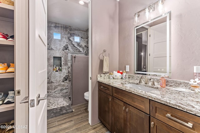 3188 W Tumamoc Dr, Tucson, AZ 85745 - full bathroom featuring wood finish floors, vanity, and a shower stall