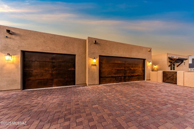 3188 W Tumamoc Dr, Tucson, AZ 85745 - view of front facade with a gate, stucco siding, and driveway