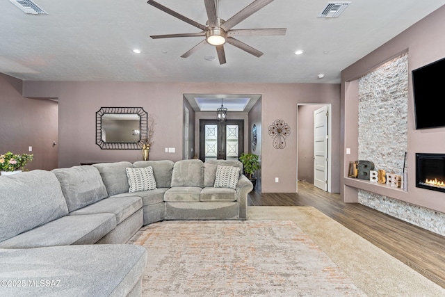 3188 W Tumamoc Dr, Tucson, AZ 85745 - living area featuring a ceiling fan, wood finished floors, a glass covered fireplace, and recessed lighting