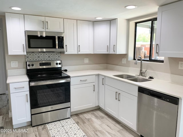 2973 S Kolb Rd, Tucson, AZ 85730 - kitchen featuring appliances with stainless steel finishes, white cabinetry, light countertops, recessed lighting, and light wood-type flooring