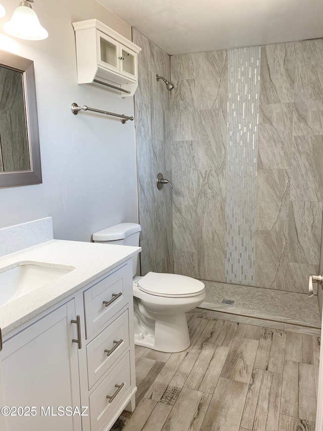2973 S Kolb Rd, Tucson, AZ 85730 - full bathroom with wood finished floors, vanity, and a tile shower