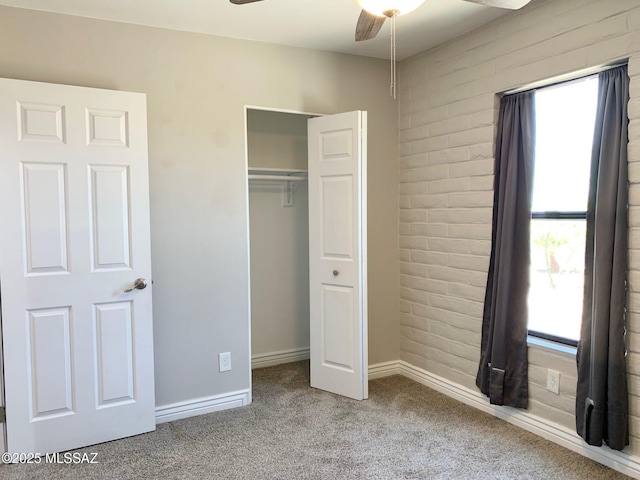 2973 S Kolb Rd, Tucson, AZ 85730 - unfurnished bedroom with multiple windows, carpet, a closet, brick wall, and ceiling fan
