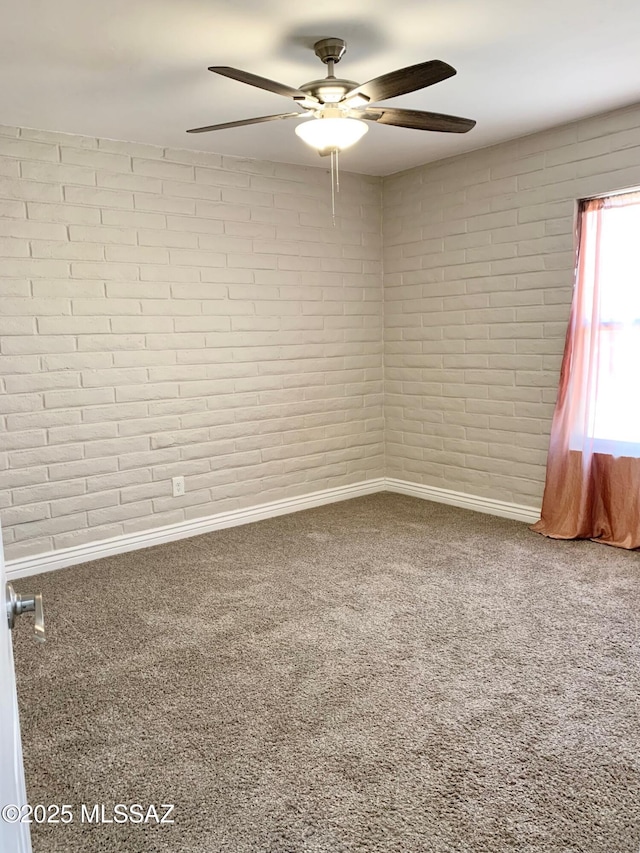 2973 S Kolb Rd, Tucson, AZ 85730 - spare room featuring carpet, ceiling fan, and brick wall