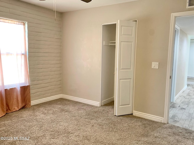 2973 S Kolb Rd, Tucson, AZ 85730 - unfurnished bedroom with multiple windows, carpet floors, a closet, and brick wall